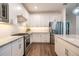 Modern kitchen featuring stainless steel appliances, white cabinets, and granite countertops at 5597 Bay Tide Ct, Land O Lakes, FL 34638