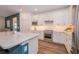 Modern kitchen featuring white cabinetry, stainless steel appliances, and a spacious island with a stone countertop at 5597 Bay Tide Ct, Land O Lakes, FL 34638