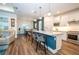 Open-concept kitchen and dining area featuring a center island, pendant lights, and modern finishes at 5597 Bay Tide Ct, Land O Lakes, FL 34638