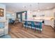 Open-concept kitchen and dining area with a center island, pendant lighting, and stainless steel appliances at 5597 Bay Tide Ct, Land O Lakes, FL 34638