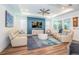 Bright living room boasts elegant tray ceilings, stylish furnishings, and a modern accent wall at 5597 Bay Tide Ct, Land O Lakes, FL 34638