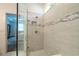 Modern shower features sleek gray tiling, glass enclosure, convenient built-in niche, and stylish fixtures at 5597 Bay Tide Ct, Land O Lakes, FL 34638