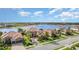 An aerial view of two tan homes with brick driveways and well-manicured landscaping at 5656 Cloverleaf Run, Bradenton, FL 34211
