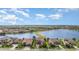 Aerial view of suburban homes with screened lanais surrounding a body of water at 5656 Cloverleaf Run, Bradenton, FL 34211