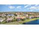 Aerial view of suburban homes with screened lanais and a marker pin surrounding a body of water at 5656 Cloverleaf Run, Bradenton, FL 34211