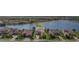 Beautiful lakefront home with lush landscaping and a private driveway in a gated community at 5656 Cloverleaf Run, Bradenton, FL 34211