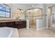 Beautiful bathroom features a granite countertop, dark wood cabinets, and large glass shower at 5656 Cloverleaf Run, Bradenton, FL 34211