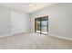 Bright bedroom with neutral carpet, closet and glass sliding doors to screened in patio at 5656 Cloverleaf Run, Bradenton, FL 34211