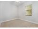 Neutral bedroom with plush carpet, ceiling fan and window with bright natural light at 5656 Cloverleaf Run, Bradenton, FL 34211