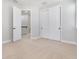 Neutral bedroom with neutral carpet, doorways to hallway and closet with bi-fold doors at 5656 Cloverleaf Run, Bradenton, FL 34211