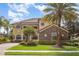 Charming two-story home with a stone facade, manicured lawn and mature trees for added curb appeal at 5656 Cloverleaf Run, Bradenton, FL 34211