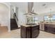 Kitchen island with range, stainless steel appliances, and granite countertops open to the living area at 5656 Cloverleaf Run, Bradenton, FL 34211