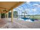 A screened outdoor pool area with a brick deck and view of the water at 5656 Cloverleaf Run, Bradenton, FL 34211