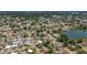 Sprawling aerial shot of neighborhood with a picturesque lake nestled amidst houses and lush foliage at 5905 Myer St, Tampa, FL 33634