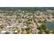 Scenic aerial view of a neighborhood near a lake, showcasing houses with manicured lawns and landscaping at 5905 Myer St, Tampa, FL 33634