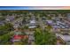 Aerial view of a neighborhood, showcasing a lake surrounded by homes and tree-lined streets at 5905 Myer St, Tampa, FL 33634