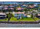 Beautiful aerial view of a waterfront property with lush green lawn and mature trees at 6106 Marbella Blvd, Apollo Beach, FL 33572