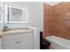 Bathroom with a white vanity, tan countertop, and a tiled shower with black toilet at 6106 Marbella Blvd, Apollo Beach, FL 33572