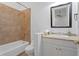 Bathroom featuring a white vanity, tan countertop, and a tiled shower at 6106 Marbella Blvd, Apollo Beach, FL 33572