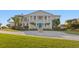 Stately two-story home featuring a circular drive and classic architectural details, perfect for luxury living at 6106 Marbella Blvd, Apollo Beach, FL 33572