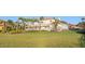 Expansive lawn showcasing a beautiful two-story home with manicured landscaping and elegant architectural details at 6106 Marbella Blvd, Apollo Beach, FL 33572