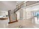 Grand foyer with a stunning staircase, elegant tile flooring, and views into the living and dining areas at 6106 Marbella Blvd, Apollo Beach, FL 33572