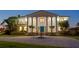 Elegant home facade featuring a circular driveway, water fountain, and well-manicured landscaping at 6106 Marbella Blvd, Apollo Beach, FL 33572