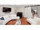 Spacious living room with white sofas, a grand piano, and access to a staircase through sliding barn doors at 6106 Marbella Blvd, Apollo Beach, FL 33572
