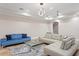 Expansive living area featuring two sofas, modern lighting, and an open layout perfect for entertaining guests at 6106 Marbella Blvd, Apollo Beach, FL 33572