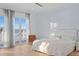 Light-filled bedroom features balcony access with water views, and a comfortable seating area at 6106 Marbella Blvd, Apollo Beach, FL 33572