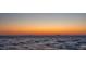 Water view of a golden sunset on the horizon at 6106 Marbella Blvd, Apollo Beach, FL 33572
