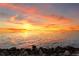 Picturesque waterfront view at sunset with gentle waves lapping the rocky shoreline at 6106 Marbella Blvd, Apollo Beach, FL 33572