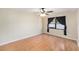 Bright bedroom featuring wood-look floors and a window with dark curtains at 6408 Bonnie Bay N Cir, Pinellas Park, FL 33781