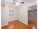 Cozy bedroom with plantation shutters, wood-look floors, and neutral paint at 6408 Bonnie Bay N Cir, Pinellas Park, FL 33781