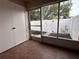 Enclosed sunroom with access to a small fenced-in yard at 6408 Bonnie Bay N Cir, Pinellas Park, FL 33781