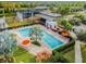 Aerial view of pool and clubhouse featuring lounge chairs and lush landscaping at 6642 Current Dr, Apollo Beach, FL 33572