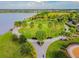 Aerial view of a park with palm trees, walking paths, and lakeside views at 6642 Current Dr, Apollo Beach, FL 33572