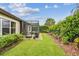 Well-maintained backyard showcasing a screened-in porch and manicured lawn at 6642 Current Dr, Apollo Beach, FL 33572