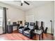 Bonus room with two recliners, desk, a ceiling fan, wood floors, and a cozy atmosphere at 6642 Current Dr, Apollo Beach, FL 33572