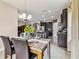 Open dining area showcasing dark wood cabinetry, granite counters, stainless steel appliances, and tile floors at 6642 Current Dr, Apollo Beach, FL 33572