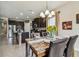 Open dining area showcases dark wood cabinetry, granite counters, stainless steel appliances, and a stylish kitchen island at 6642 Current Dr, Apollo Beach, FL 33572