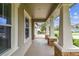 Inviting covered front porch with decorative stone pillars and neutral tones, perfect for relaxing outdoors at 6642 Current Dr, Apollo Beach, FL 33572