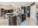 Spacious kitchen with dark cabinetry, stainless steel appliances, a breakfast bar, and tiled flooring at 6642 Current Dr, Apollo Beach, FL 33572