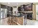 Beautiful kitchen featuring dark wood cabinets, granite countertops, stainless steel appliances, and breakfast bar at 6642 Current Dr, Apollo Beach, FL 33572