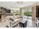 Bright and airy living space with a seamless flow from the kitchen to the outdoor patio through sliding glass doors at 6642 Current Dr, Apollo Beach, FL 33572