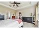 Main bedroom with a tray ceiling, neutral color palette, and well-placed dressers for ample storage at 6642 Current Dr, Apollo Beach, FL 33572