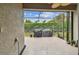 Covered and screened patio with outdoor furniture and view of landscaped backyard at 6642 Current Dr, Apollo Beach, FL 33572