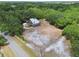 Aerial view of house surrounded by lush trees, and large yard at 7606 Four Pines Rd, Plant City, FL 33565
