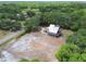 Aerial view of the property, showing the large yard, lush trees, and road access at 7606 Four Pines Rd, Plant City, FL 33565