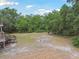 Expansive backyard with a rustic fire pit offering ample space and outdoor entertainment options at 7606 Four Pines Rd, Plant City, FL 33565